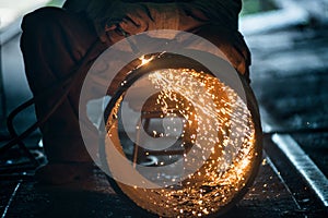 Worker doing a industrial welding in a workshop