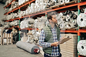 Worker doing an inventory check on a warehouse floor