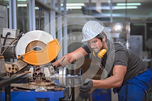Worker doing work with  metal lathe machine carving