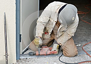 Worker Drilling Door Jam