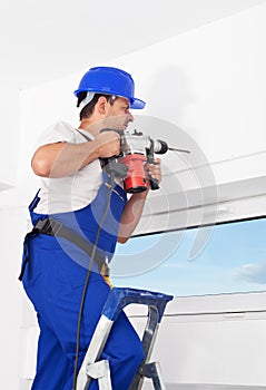 Worker drilling hole