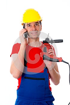 Worker with drilling machine is calling