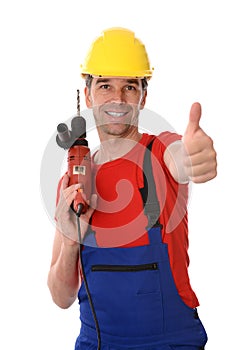 Worker with drilling machine and thumb up