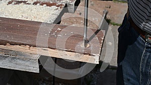 Worker drilling wood.