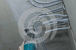 Worker drills a concrete wall with a hammer drill