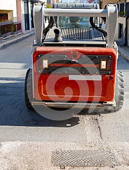 Worker driver Skid steer remove Worn Asphal