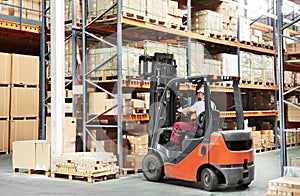 Worker driver at warehouse forklift photo