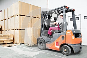 Worker driver at warehouse forklift