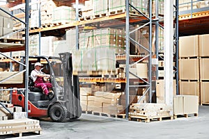 Worker driver at warehouse forklift loader works