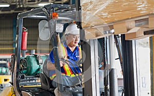 Worker driver at warehouse forklift loader works to containers box, worker man in warehouse with forklift