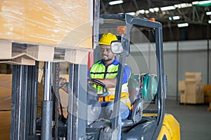 Worker driver at warehouse forklift loader works to containers box, worker man in warehouse with forklift