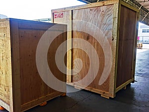 Worker driving forklift loading shipment carton boxes goods on wooden pallet at loading dock from container truck to warehouse car