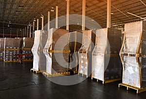 Worker driving forklift loading and unloading shipment carton boxes and goods on wooden pallet from container truck to warehouse c