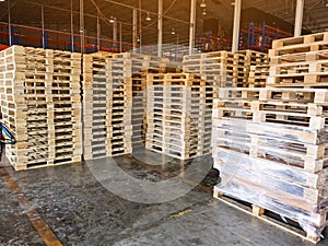 Worker driving forklift to loading and unloading wooden pallets from truck to warehouse cargo storage, shipment in logistics and t