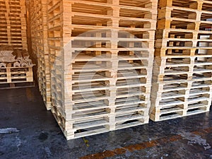 Worker driving forklift to loading wooden pallets from truck to warehouse cargo storage, shipment in logistics and transportation