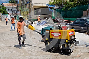 Worker dubs the ground using machine