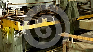 The worker is engaged in cutting of metal on the production automatic machine tool, metal cutting, press