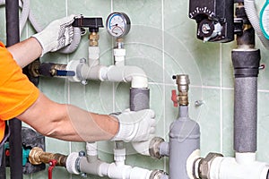 A worker or an engineer checks the operation of the heating system.