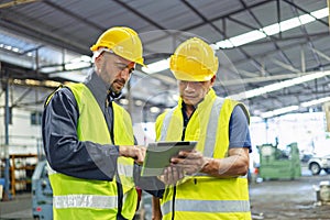 worker and engineer using tablet computer for inspection and checking production process on factory station