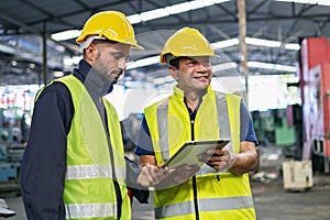 worker and engineer using tablet computer for inspection and checking production process on factory station