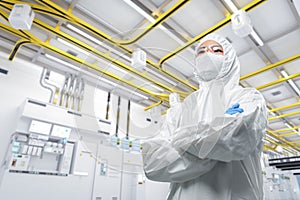 Worker or engineer wears protective suit or coverall suit work in semiconductor manufacturing factory