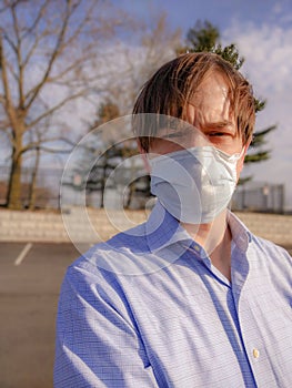 Worker in Facemask, Exhausted but Determined to Push Onward photo