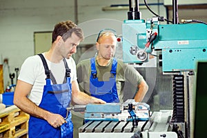 Worker in factory on the machine