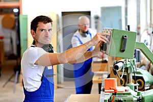Worker in factory using machine