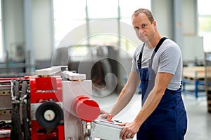 Worker in factory using machine