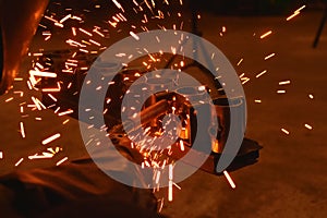 Worker at the factory welding steel structure.