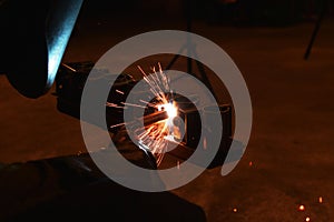 Worker at the factory welding steel structure.