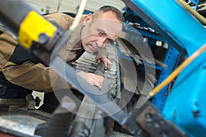 Worker in factory working on metalworks machine