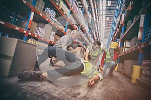 Worker fallen down while carrying cardboard boxes