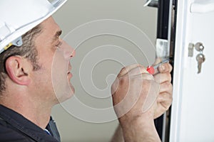 worker fasten handle to plastic window