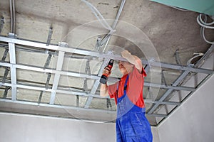 Worker fastens profile using cordless