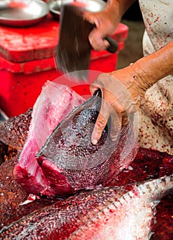 Worker filleting a fresh caught saltwater fish