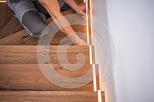 Worker Finishing LED Stairs Illumination Installation