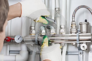 Worker fixing heating system, close up photo