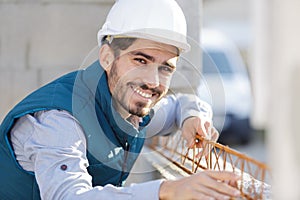worker fixing steel rebar at building site