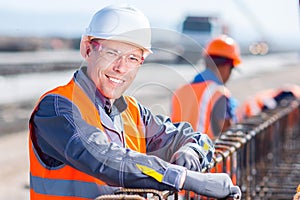 Worker fixing steel rebar at building site