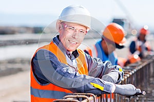 Worker fixing steel rebar at building site