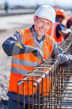Worker fixing steel rebar at building site