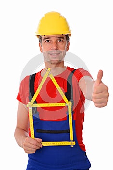Worker with folding yardstick- house and thumb up