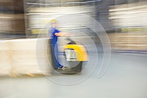 A worker of forklift is moving in a huge distribution warehouse