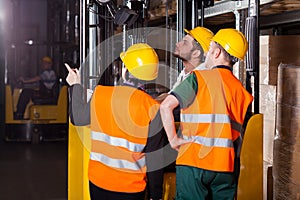 Worker on forklift in warehouse