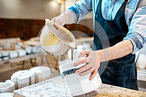 Worker forming ceramics at the pottery manufacturing