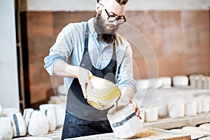 Worker forming ceramics at the pottery manufacturing