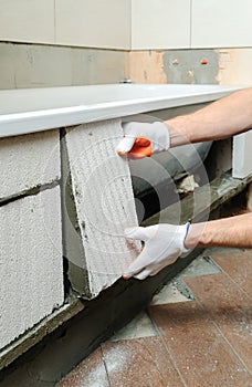 Worker forms the sidebar bath. photo