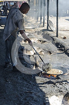 Worker frying fish