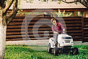 worker gardening and doing landscaping works, using professional tools and machinery